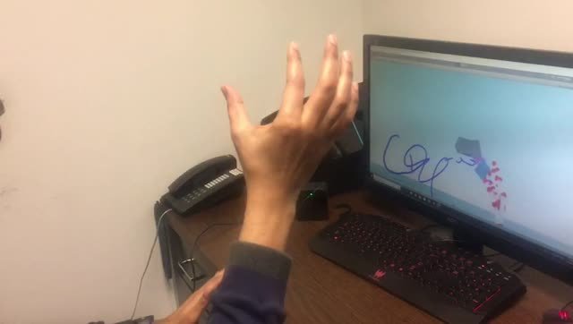 Hand-tracking writing demonstration shown on a desktop display